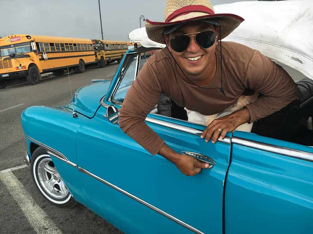 Putting roof on car in Havana