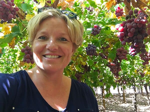 Megan standing under grape vines Mildura
